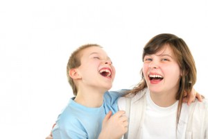 happy brother and sister laughing isolated on the white